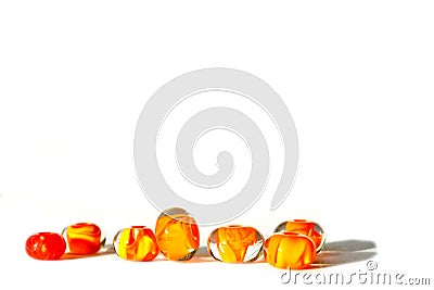 Beautiful colorful cheerful background made of handmade lampwork beads with flames inside. Beads are s isolated on white backgroun Stock Photo