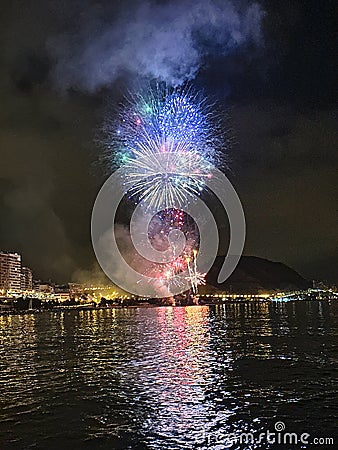 colorful fireworks in the night sky on the seafront of Alicante spain Stock Photo