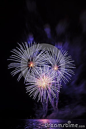 Beautiful colorful fireworks on water. Purple fireworks reflection. Brno dam. International Fireworks Competition Ignis Brunensis. Stock Photo