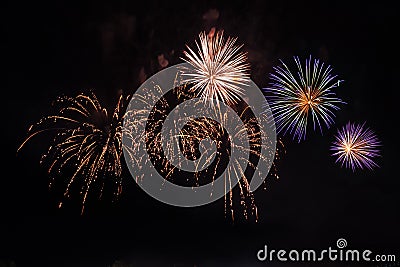 Beautiful colorful holiday fireworks on the black sky background, long exposure Stock Photo