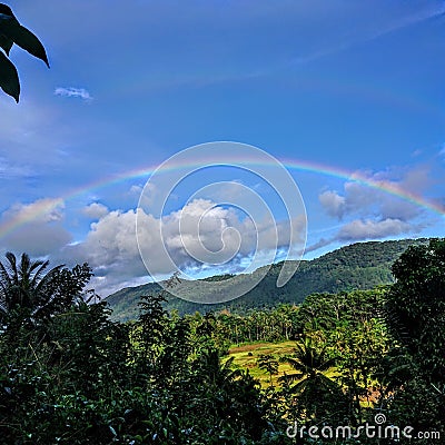 Beautiful and colorful rainbow in sky Stock Photo