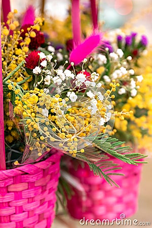 Beautiful colorful spring background with flowers in a wicker pink baskets, close-up. Copy space for greeting postcard Stock Photo