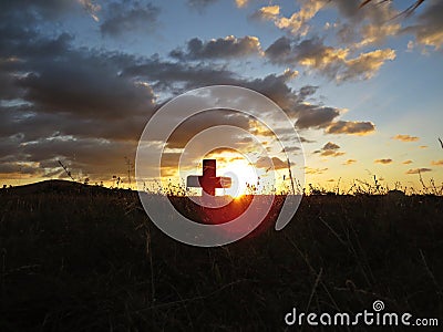 Beautiful Colorful Sunset Over Cross on Churchyard Cemetery Graveyard Stock Photo