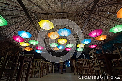 Beautiful colorfull umbrellas lamps into a Colombian Guajira hostel restaurant Stock Photo