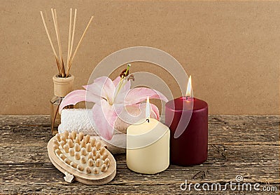 Beautiful composition with candles, spa towels and massage brush on wooden background Stock Photo