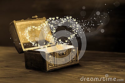 Beautiful concept of vintage chest with light heart miracle on w Stock Photo