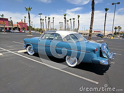Light blue and white 1950s Ford Crestline in parking lot - rear driver side view Editorial Stock Photo