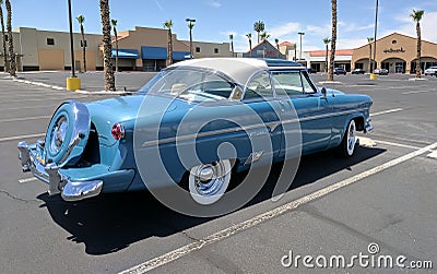 Light blue and white 1950s Ford Crestline in parking lot - rear passenger side view Editorial Stock Photo
