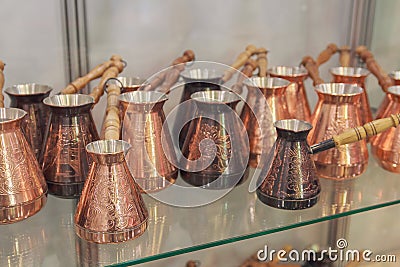 Beautiful copper cezve on the shelves Stock Photo