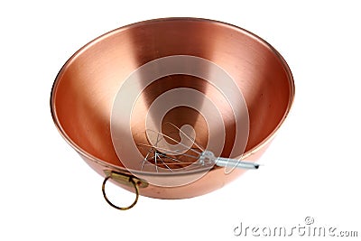 A beautiful copper mixing bowl with a whisk in it on white with nice reflections Stock Photo
