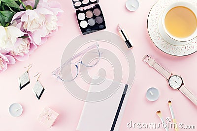 Beautiful cosmetics and flowers flat lay with note book, herbal tea on pastel background Stock Photo