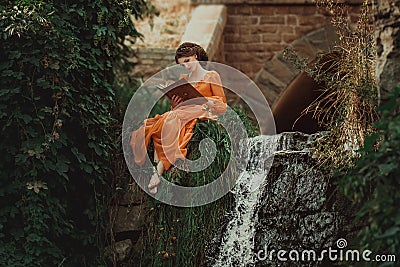 The beautiful countess in a long orange dress Stock Photo