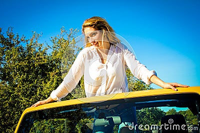 Beautiful Country Girl posing on a vehicle Stock Photo
