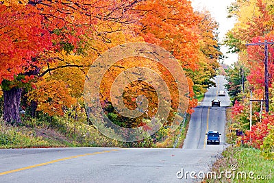 Beautiful country road in autumn foliage Stock Photo