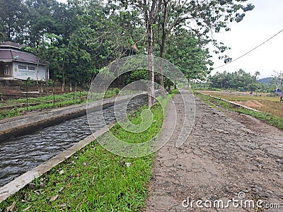 Beautiful country road with a river flowing beside it. Natural concept. In indonesia Editorial Stock Photo