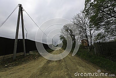 Beautiful country road in the summer. Asphalt or dirt road in the suburbs Stock Photo