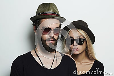 Beautiful couple in hat wearing trendy glasses together. Hipster boy and girl Stock Photo