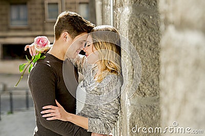 Beautiful couple in love kissing on street alley celebrating Valentines day Stock Photo