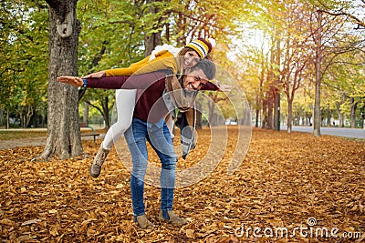 Beautiful couple piggy back in autumn Stock Photo