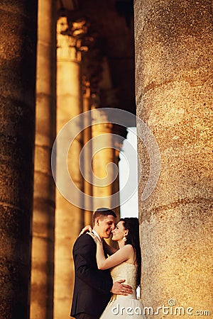 Beautiful couple in wedding dress outdoors near the volumn Stock Photo