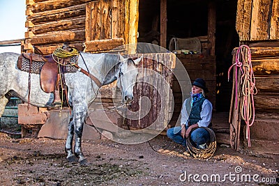 Beautiful Cowgirl in Western Scene Stock Photo