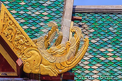 Beautiful craved crocodile pattern on the rafter and gable. Stock Photo