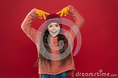 Beautiful crazy. Crazy child show horns on head. Happy girl with crazy look red background. Crazy holiday mood. Winter Stock Photo