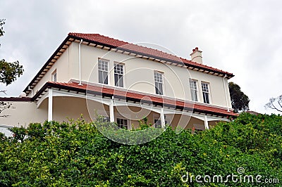Beautiful cream and red house and trees Stock Photo