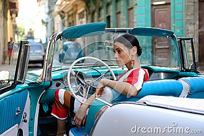 Beautiful Cuban woman in the classical American car Editorial Stock Photo