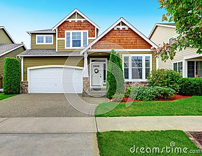 Beautiful curb appeal of American house in olive exterior paint. Stock Photo