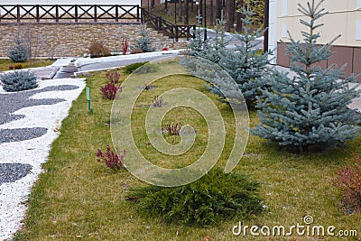 Beautiful curb appeal of a classic holiday home in Siberia with a beautiful front yard landscaping. Image of landscaping. Stock Photo