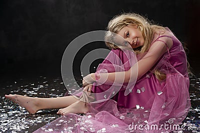 Beautiful curly blonde teenager child girl wearing a pink air dr Stock Photo