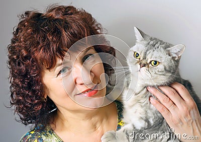 A woman holding a cat of British breed Stock Photo