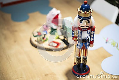 Beautiful and cute modern wooden soldier as a Christmas decoration on a wooden table Stock Photo