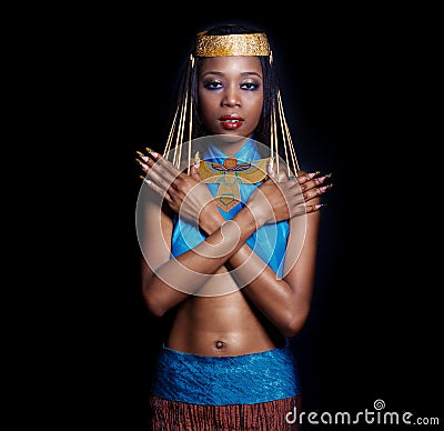 Beautiful dark-skinned girl black woman in the image of the Egyptian queen with red lips bright makeup demonstrates long nails Stock Photo