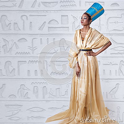 Beautiful dark-skinned girl black woman in the image of the Egyptian queen with red lips bright makeup demonstrates long nails Stock Photo