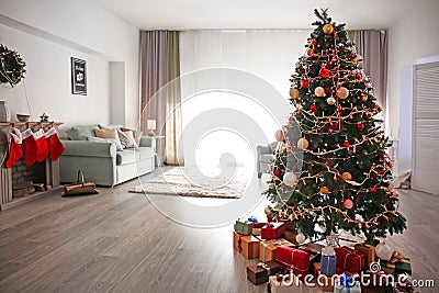 Beautiful decorated Christmas tree in cozy living room Stock Photo