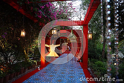 Beautiful decorated entrance with floral decoration and lamps at indian wedding or reception ceremony, outdoor evening Editorial Stock Photo