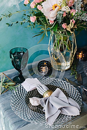 Beautiful decorated wedding table with bridal bouquet, flowers, glass, candles Stock Photo