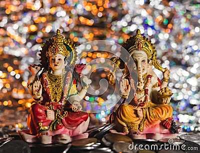 Beautiful decoration of Ganesh-Lakshmi statues in Diwali on a pile of coins Stock Photo