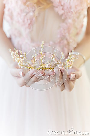 Beautiful delicate crown in the style of fine art at the hands of-girl bride Stock Photo