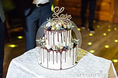 Beautiful delicious white wedding cake at the evening Stock Photo