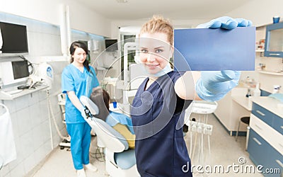 Beautiful dentist with business cand in her hand Stock Photo