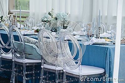 Beautiful dinner setting, long table set for an event on a terrace Stock Photo