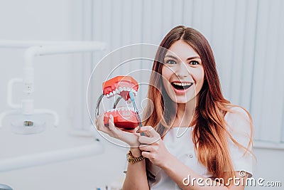 Beautiful doctor orthodontist shows you how to care for your teeth Stock Photo