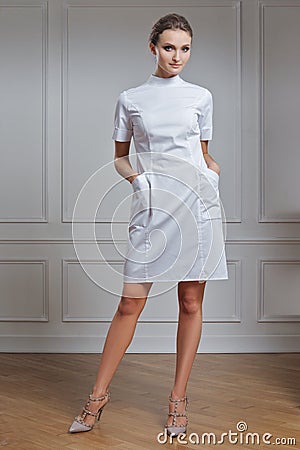 Beautiful doctor in white clothes. Portrait of attractive medic in white robe Stock Photo