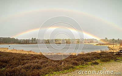 Double rainbow over Haterse en Overasseltse Vennen in the Netherlands Stock Photo