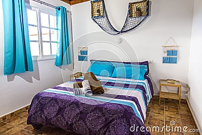 A beautiful double room with a large bed. A room in the Greek style. Blue room. A double room in the Hotel. A large bed in a hotel Editorial Stock Photo