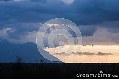 Beautiful, dramatic, colorful clouds and sky before sunrise over the Aegean sea Stock Photo