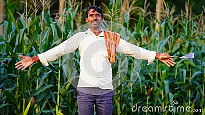 Beautiful dramatic portrait of Indian rural happy farmer standing in field wearing shirt pant in summer time Editorial Stock Photo